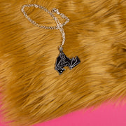 black bat necklace on faux fur backdrop