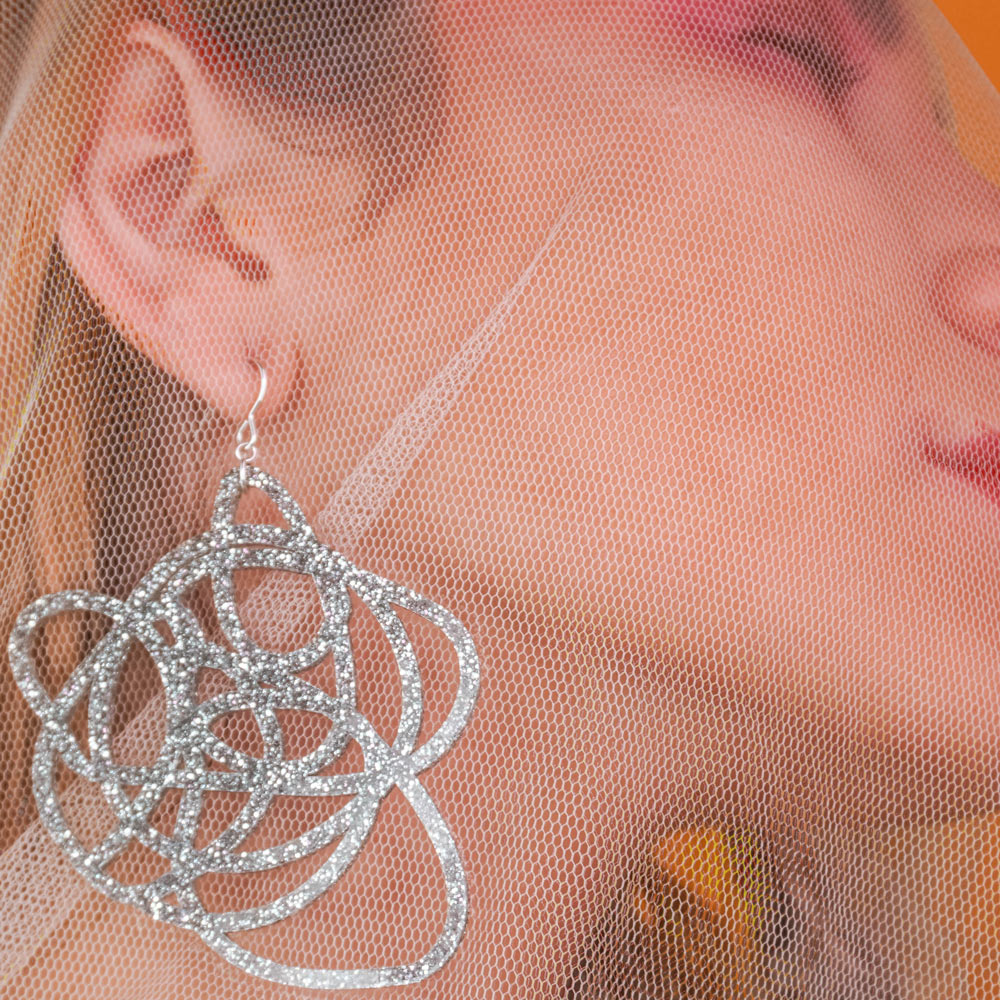 Silver Glitter Abstract Earrings on Model