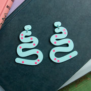 Aqua Squiggle earrings with pink polka dots on dark blue background