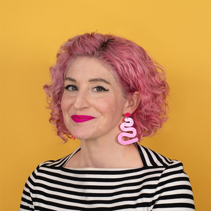 Hot pink acrylic earrings on model