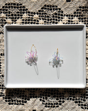 iridescent flower gold hoop earrings on white tray
