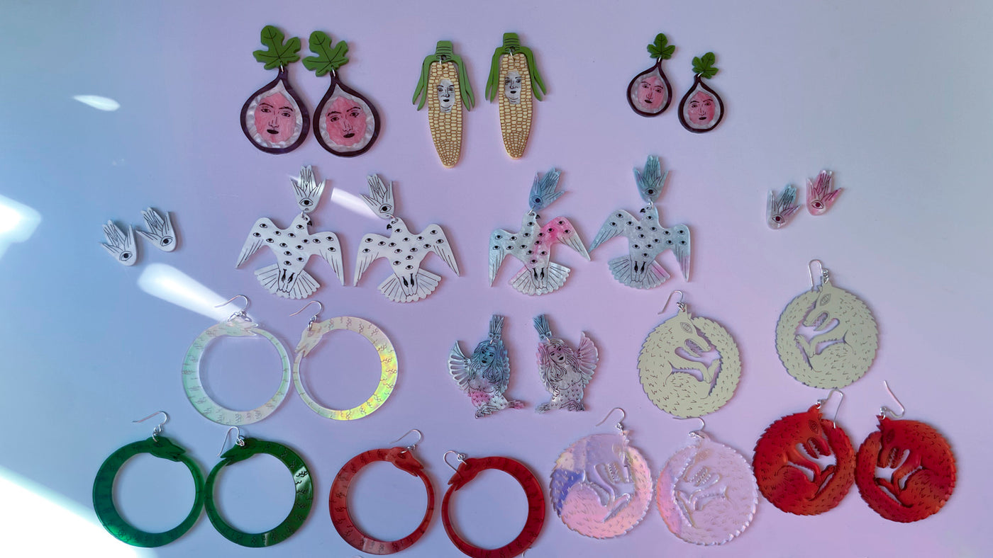 earring collection on multicolored background

