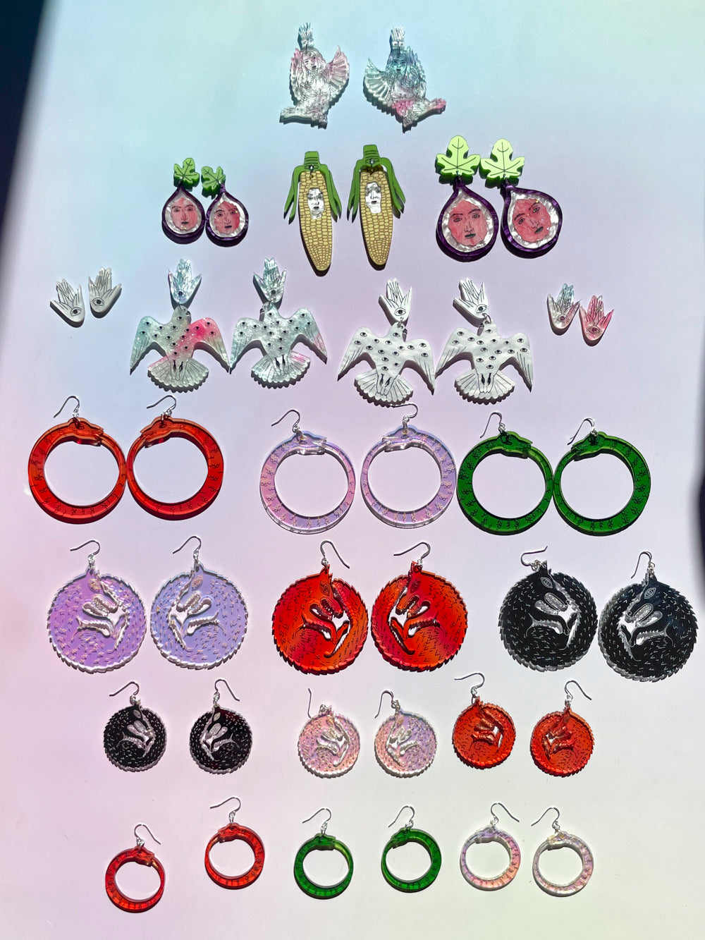 earring collection on multicolored background