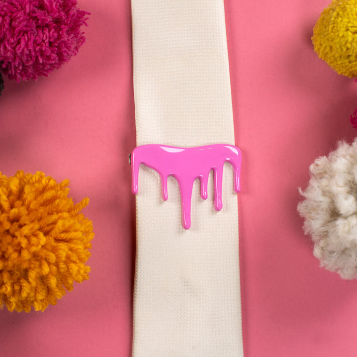Pink drip tie clip on white tie