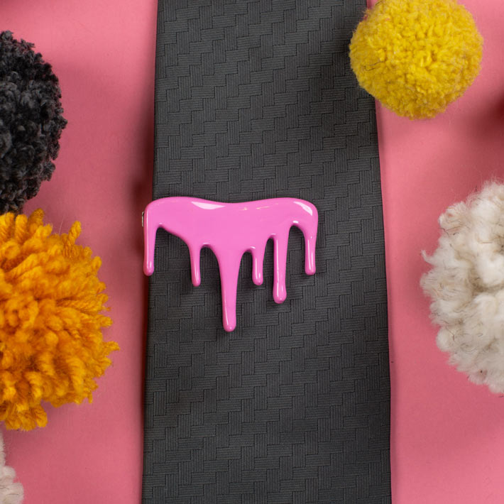 pink drip tie clip on wide gray tie
