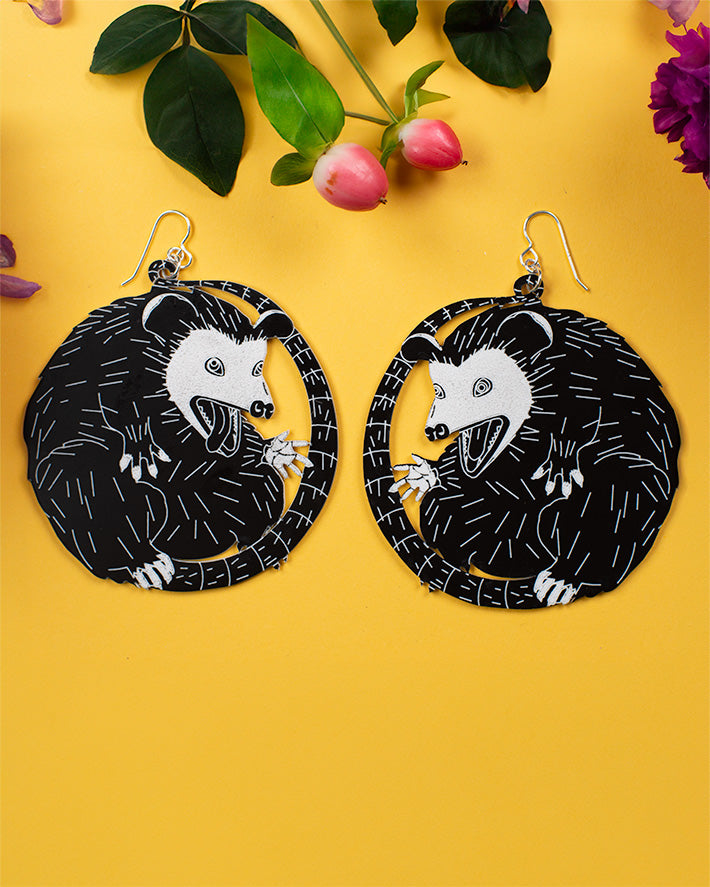 Large possum earrings over white
