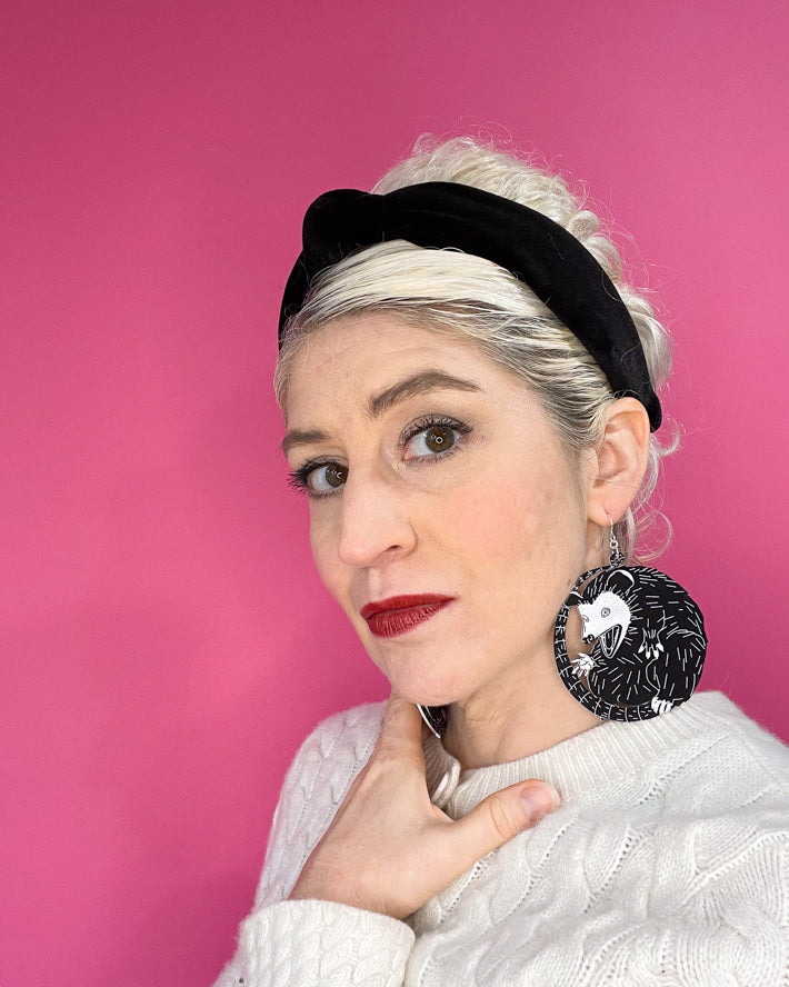 Model wearing large possum earrings