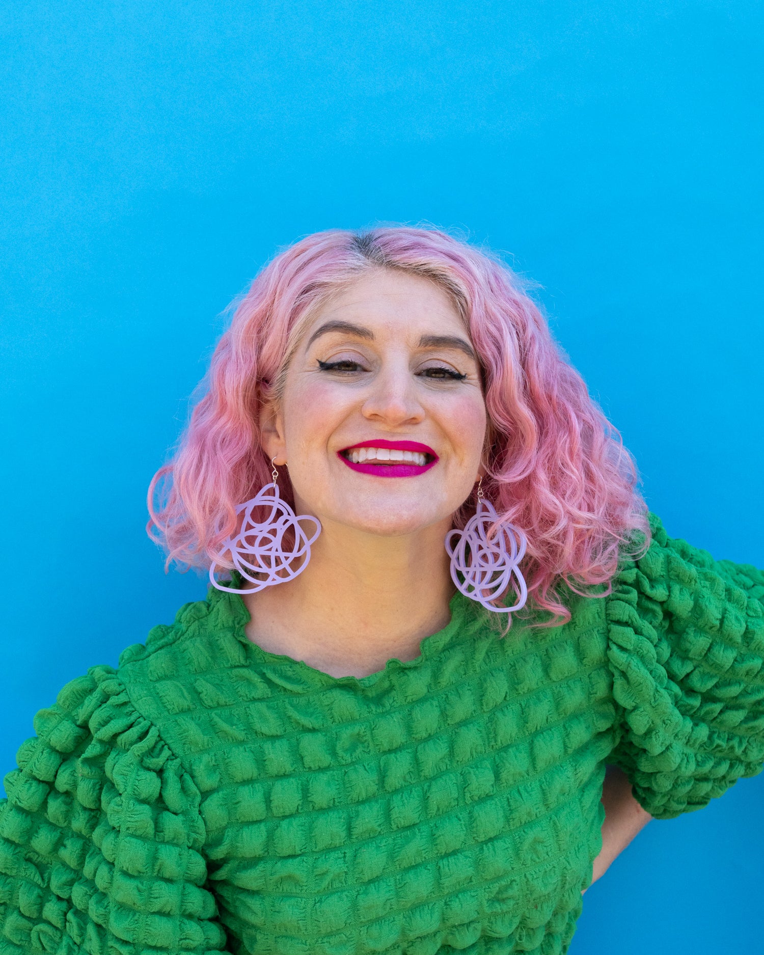 Purple grande earrings on model