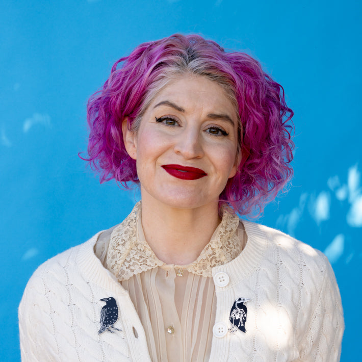 Model wearing both raven pins