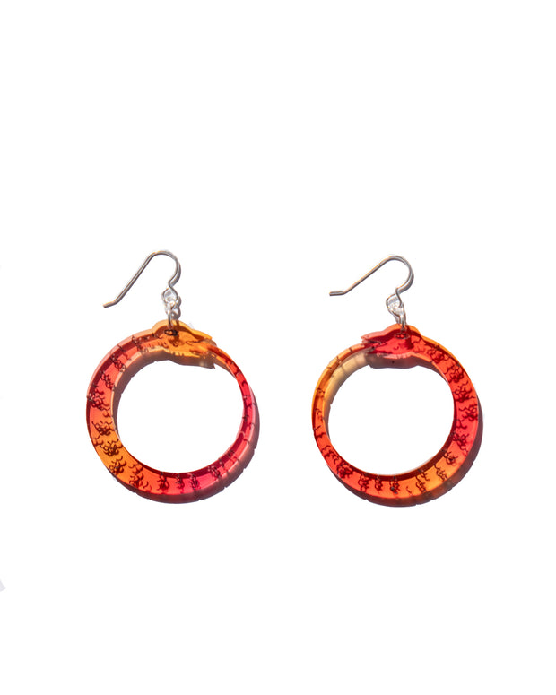 small red orange ouroboros earrings on white background