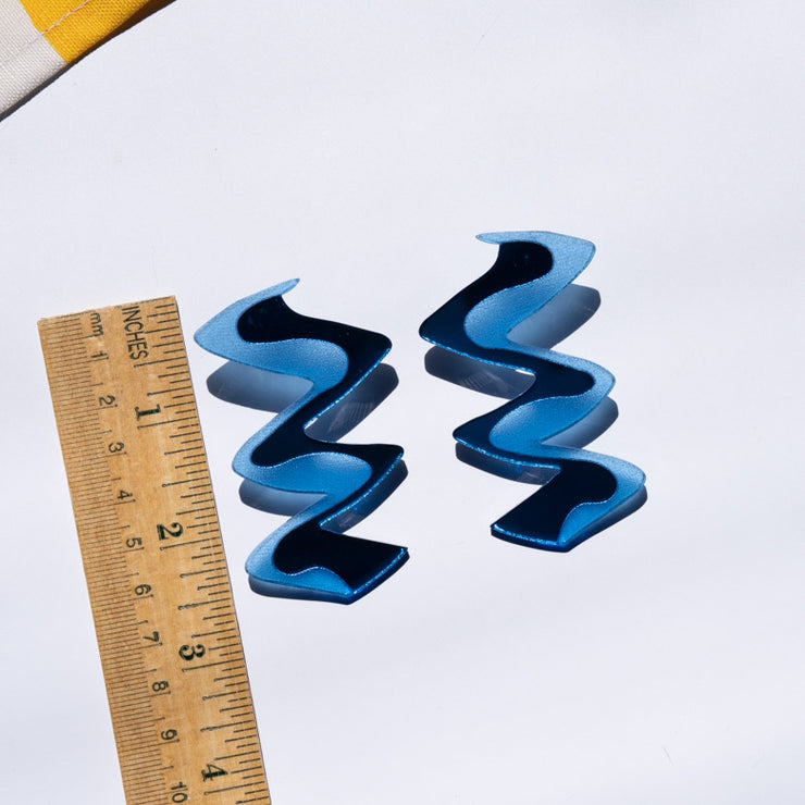Zigzag blue earrings shown with wooden ruler