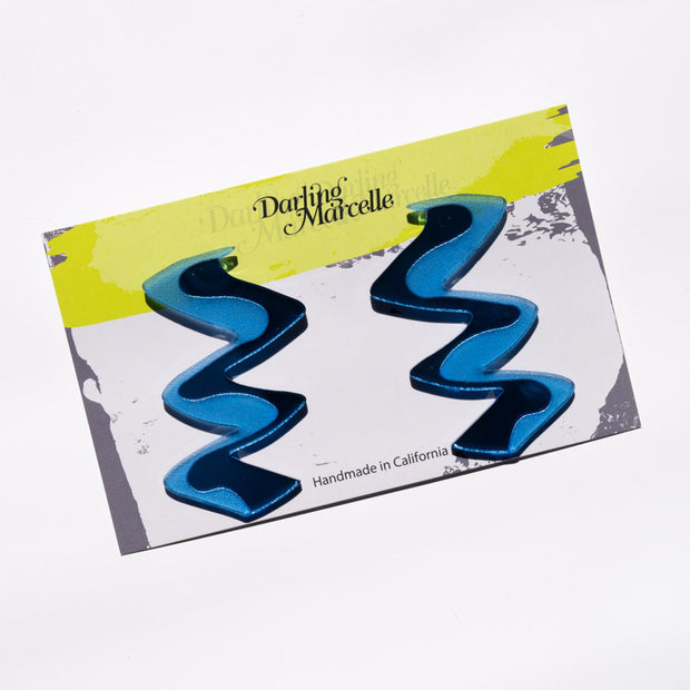 Zigzag blue acrylic earrings shown on earring card