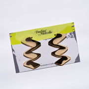 Zigzag gold acrylic earrings shown on card