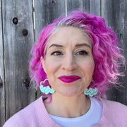 Aqua cloud earrings on white model with pink hair