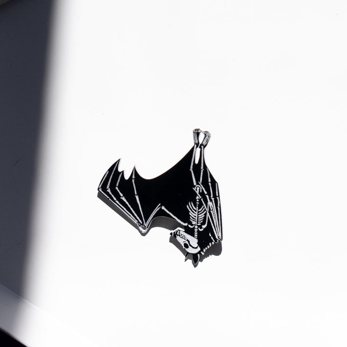 black and white skeleton pin on white tray