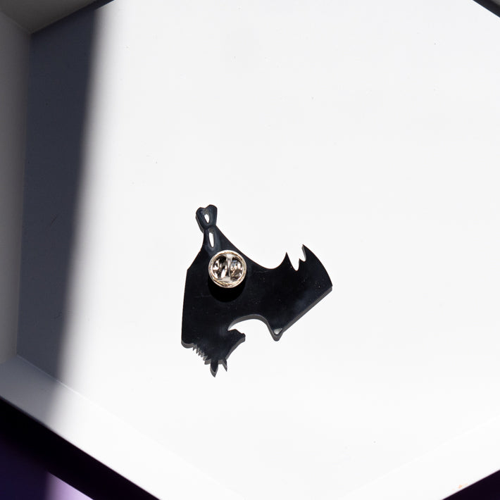 back side of black skeleton pin