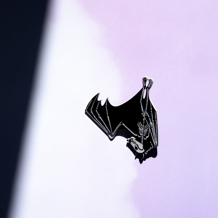 black and white bat skeleton pin