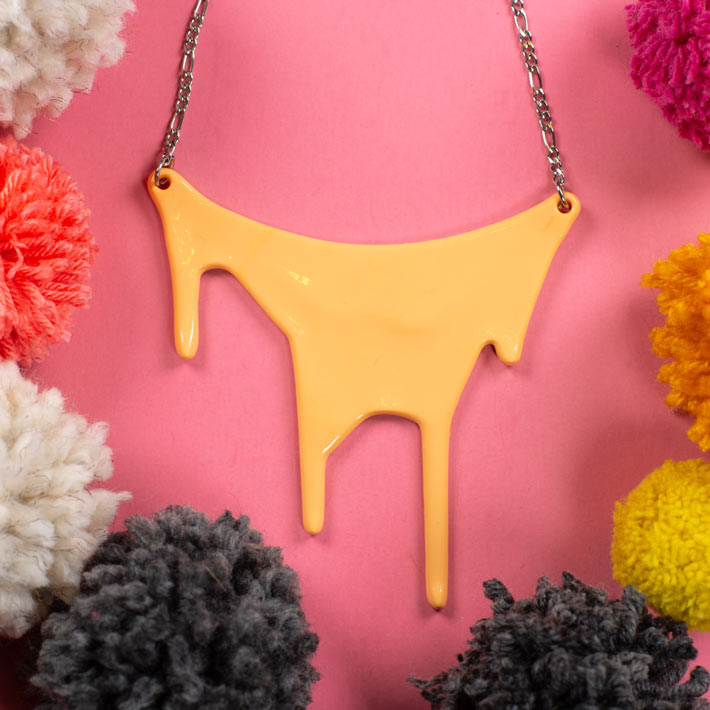 Peach pastel statement necklace over pink background