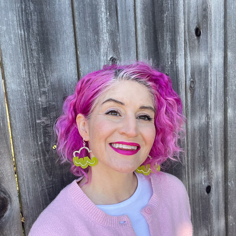 lime green cloud earrings on white model with pink hair