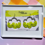 lime green cloud earrings on earring card atop white tray