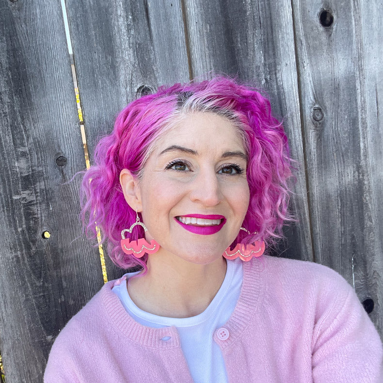 pink cloud earrings shown on pink-haired white model