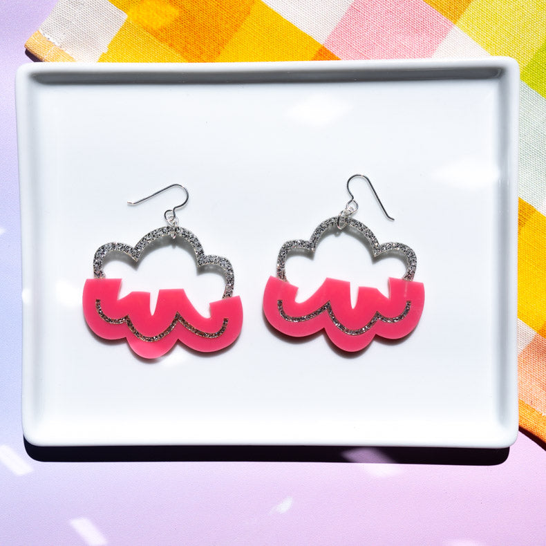 Pink cloud earrings on white tray