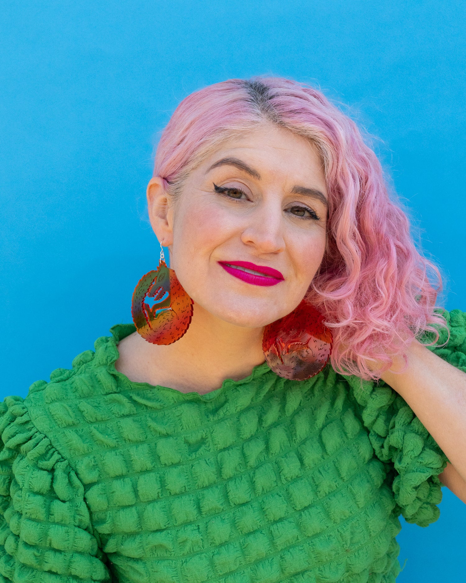 Large red wolf earrings on model