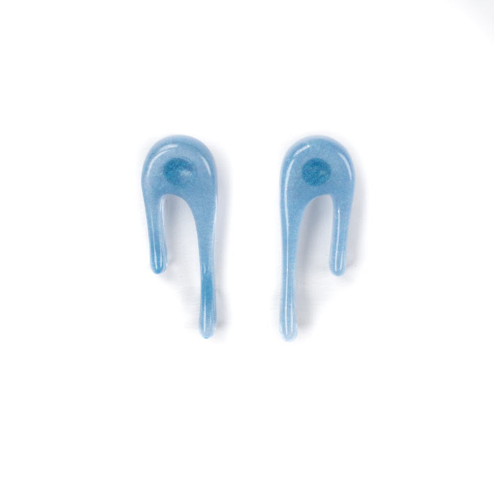 translucent blue stud earrings over white