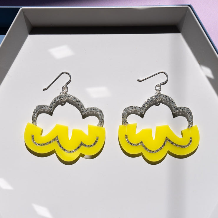 silver and yellow cloud earrings shown on white tray