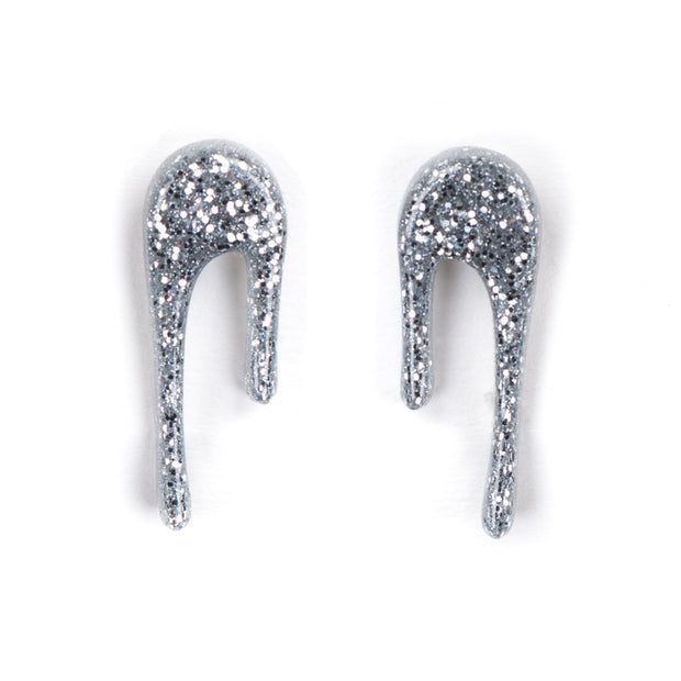 sparkly silver stud earrings over white