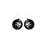 small black wolf earrings on white background