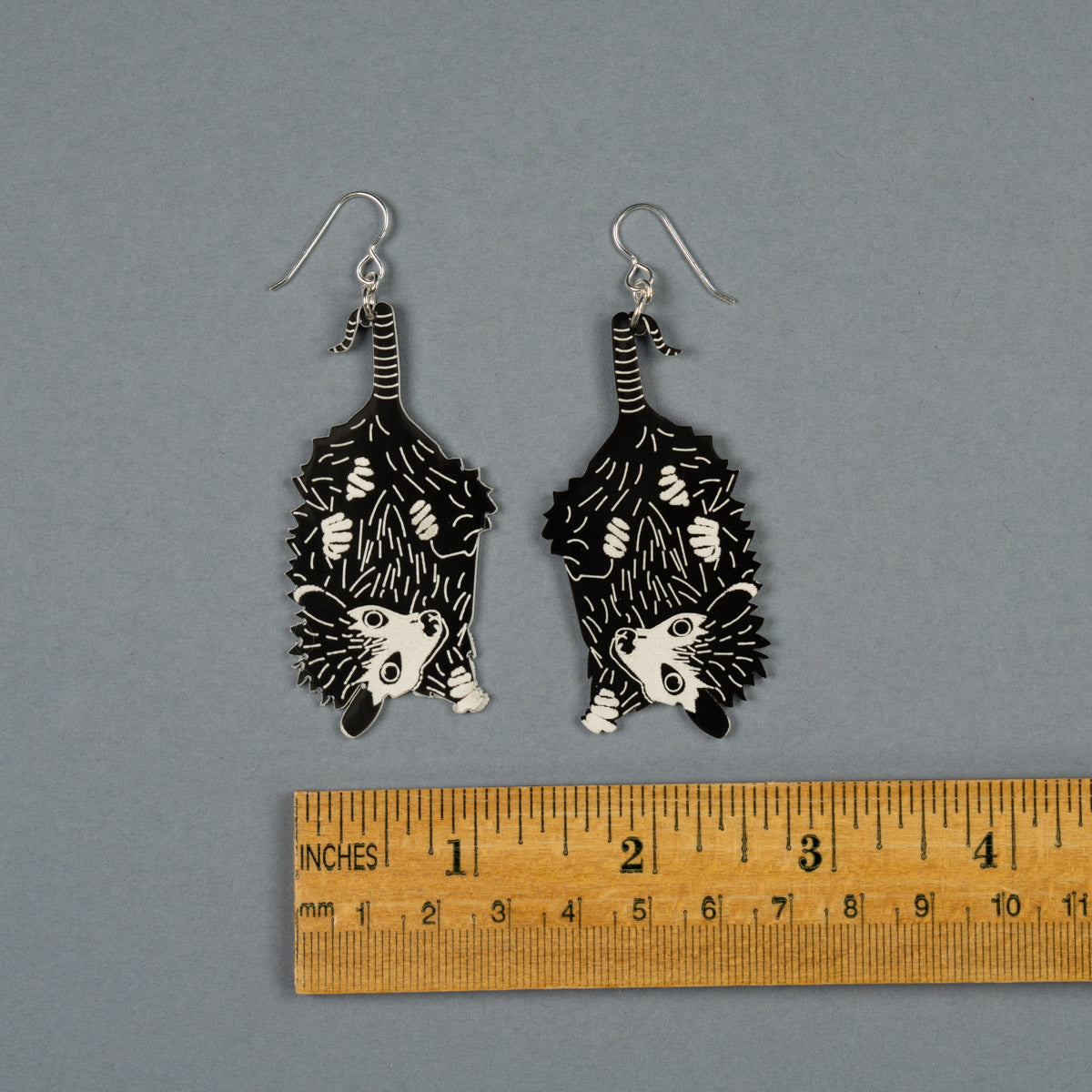 Small Baby Possum Earrings shown above ruler