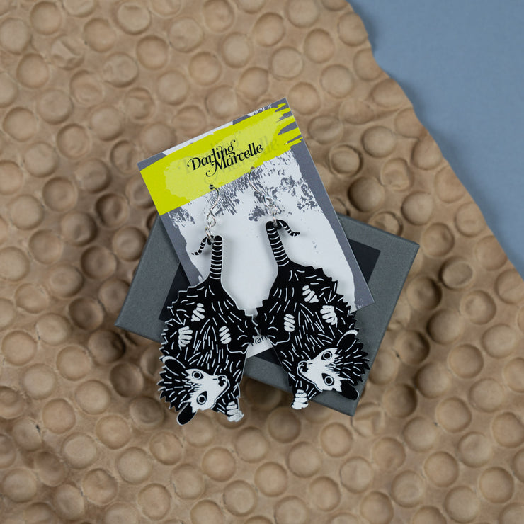 Small Baby Possum Earrings shown in packaging