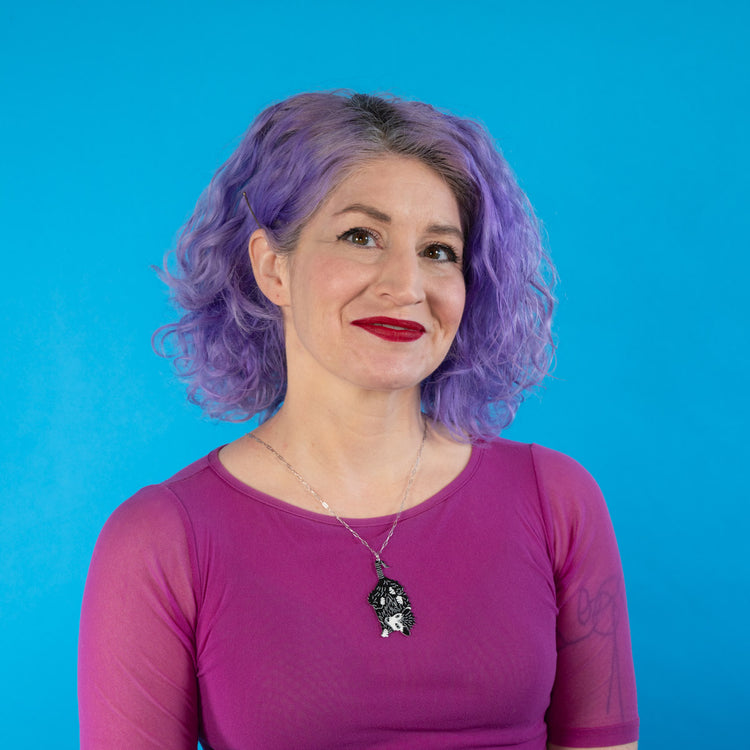 Baby possum necklace shown on model 