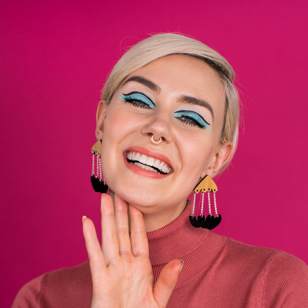black and wood dangle earrings on model