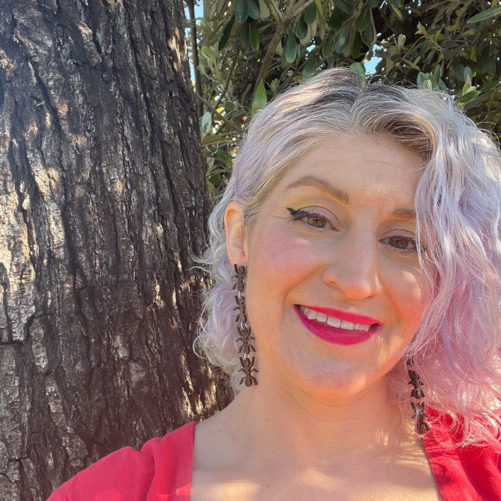 black ant earrings on model