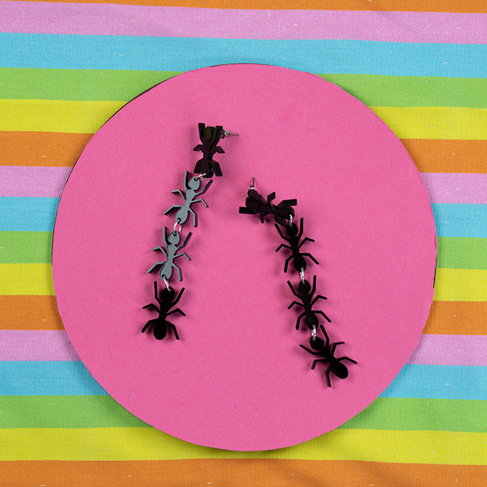 Black Ant Earrings on colorful background
