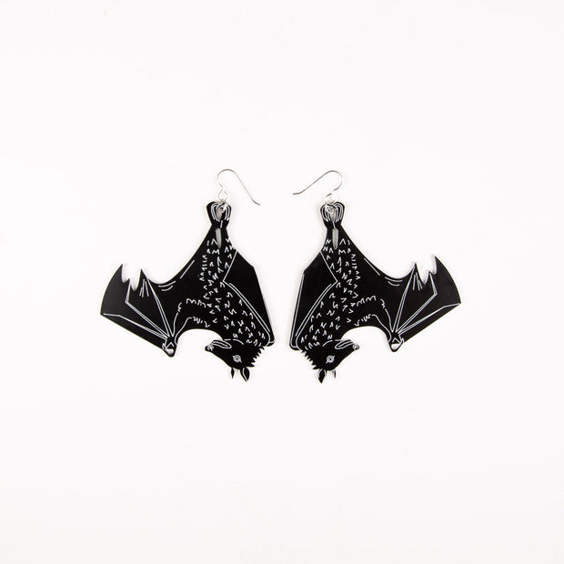 Large black bat earrings on white background
