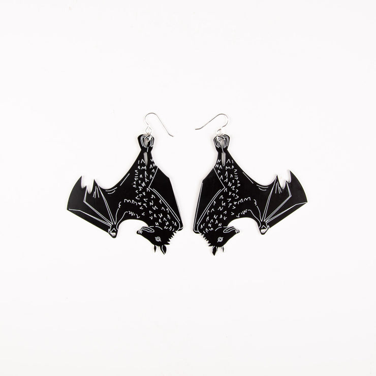 Large black bat earrings on white background