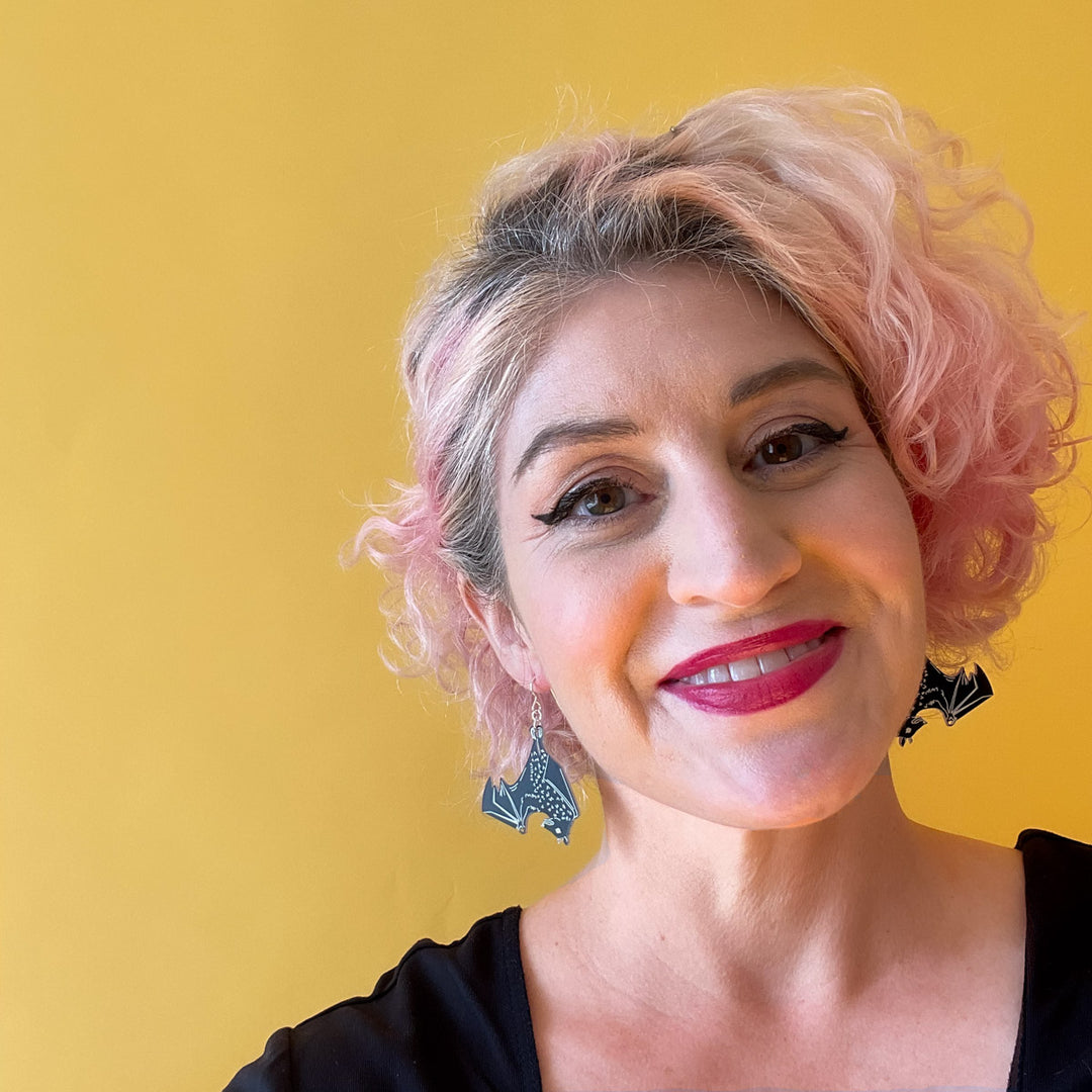 black bat earrings shown on model