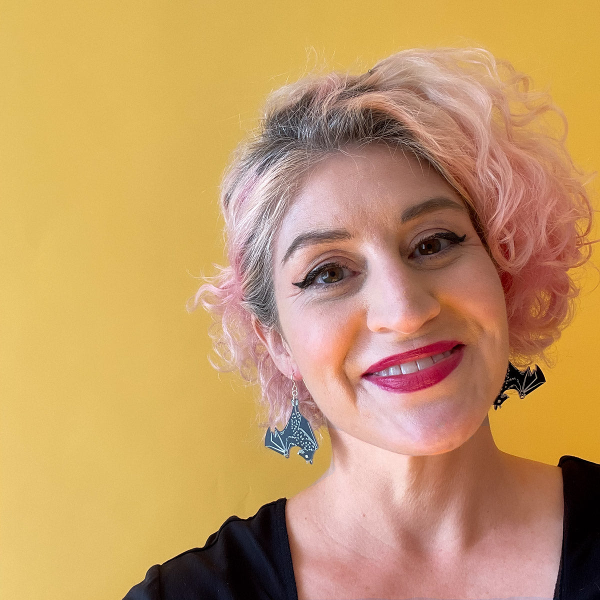 black bat earrings shown on model