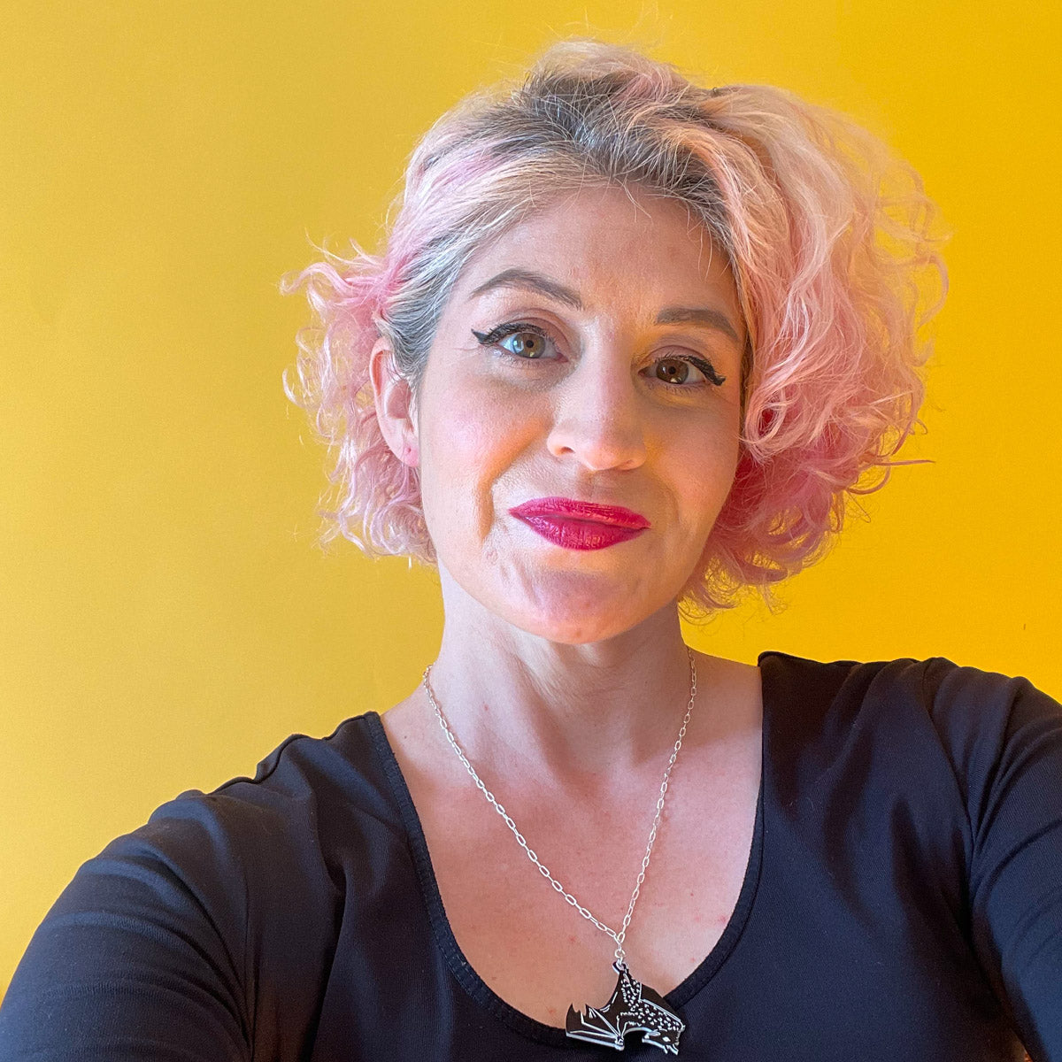 Black bat necklace shown on model