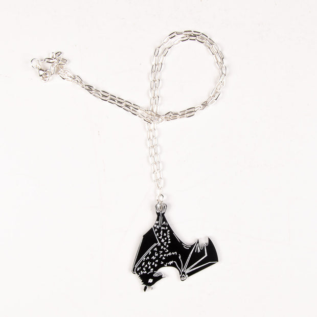 black bat necklace on white background