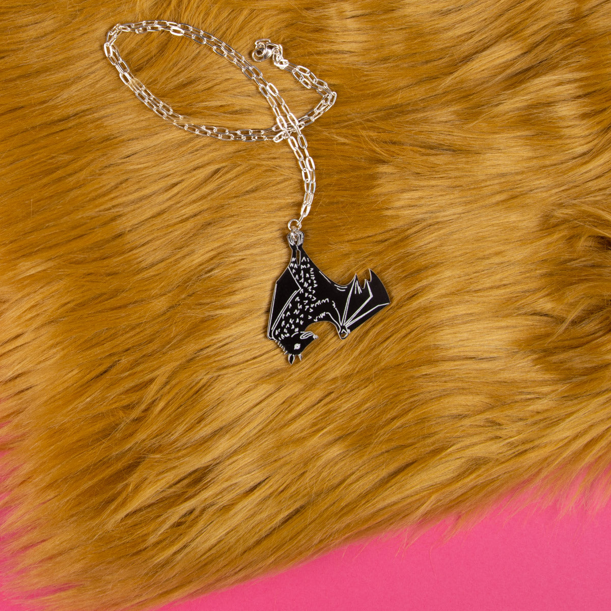 black bat necklace on faux fur backdrop