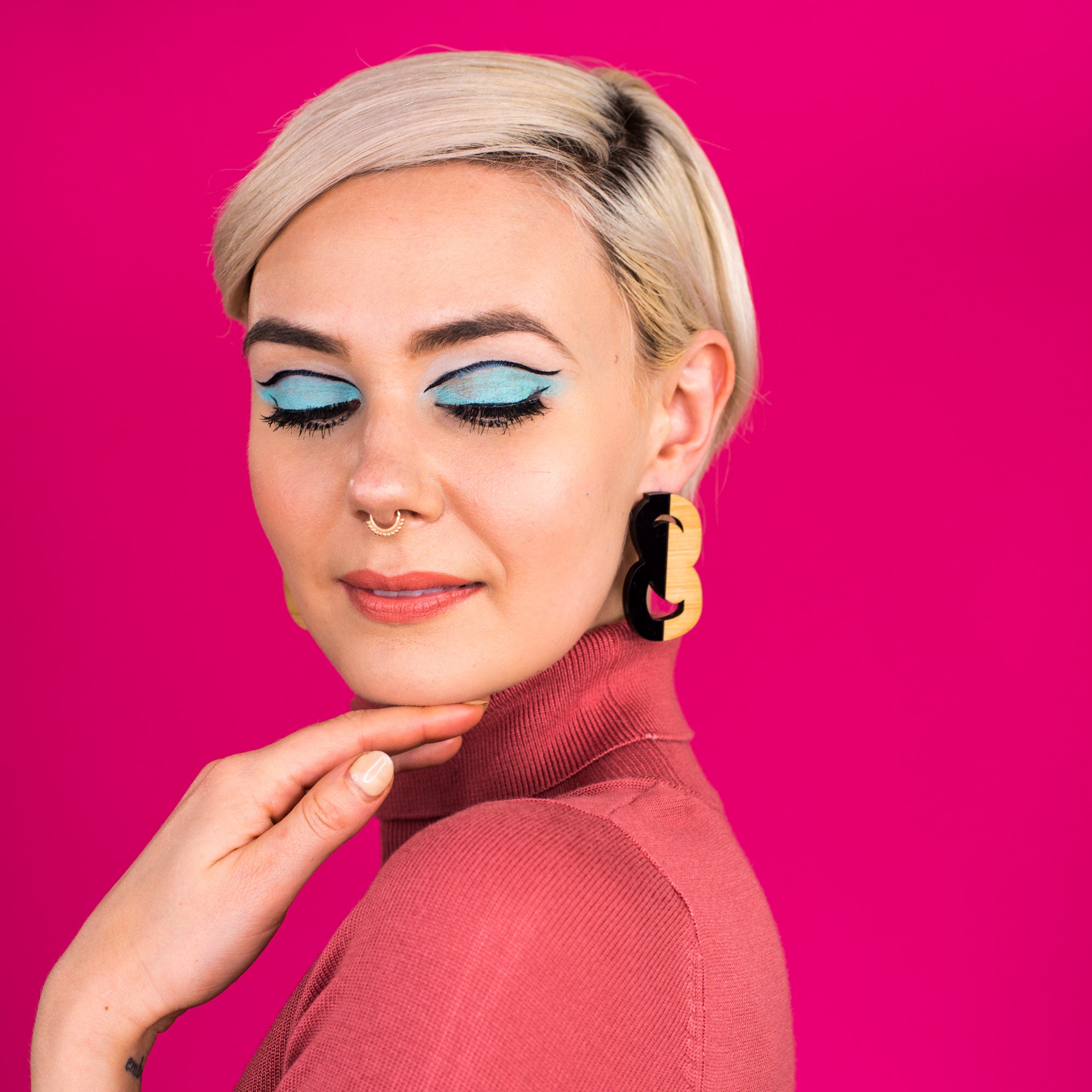 Black and wood statement stud earrings on model