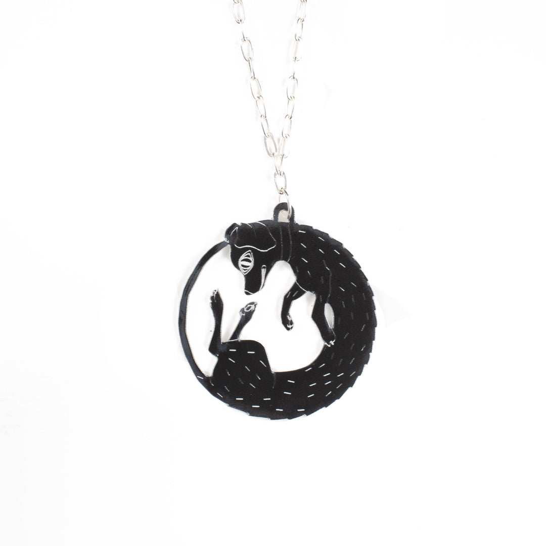 black dog necklace over white