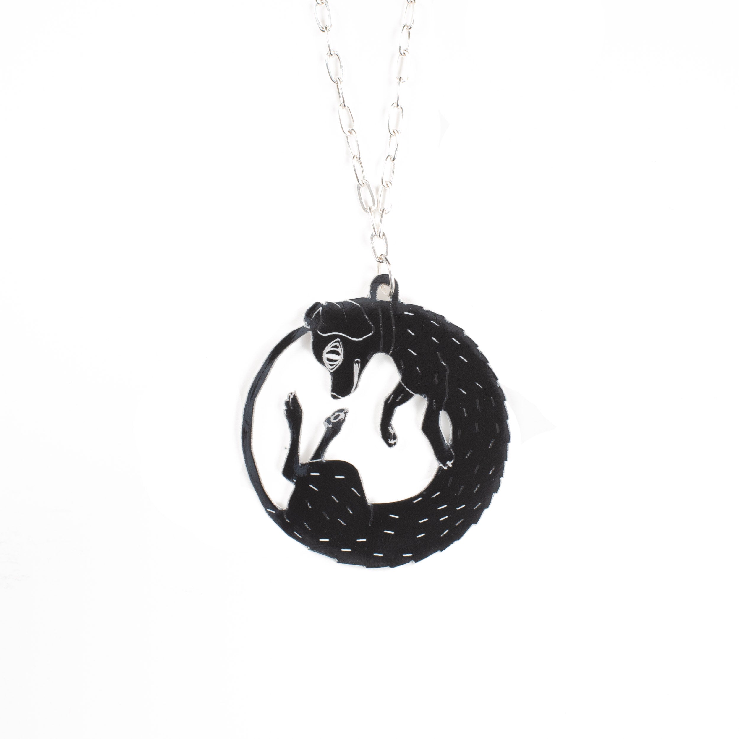 black dog necklace over white
