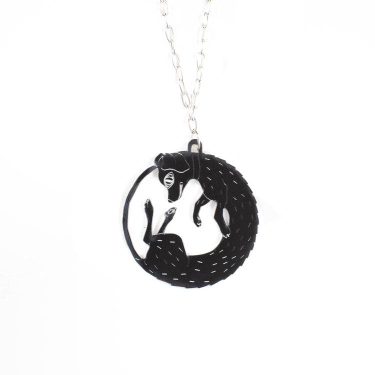 black dog necklace over white