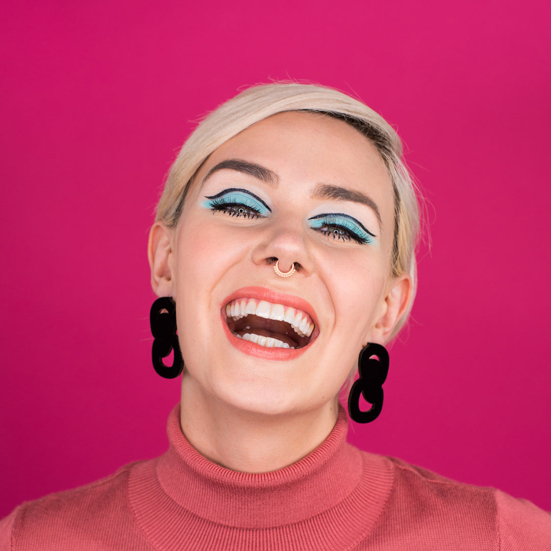 black statement stud earrings on model