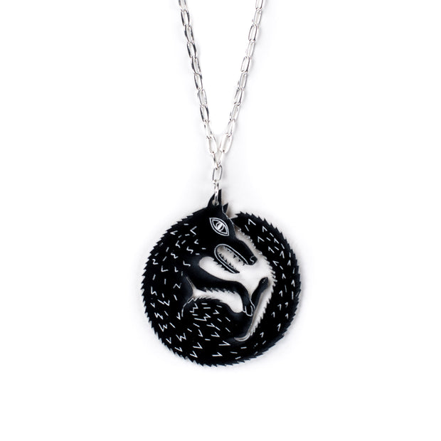 black wolf necklace on white background